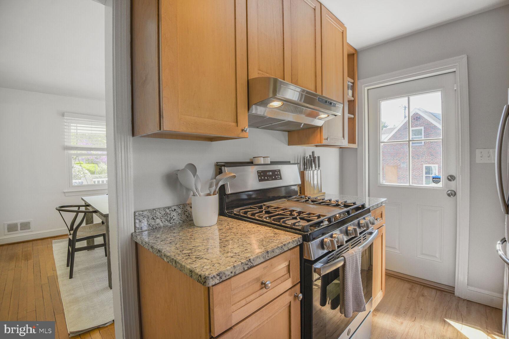 10002 Reddick Drive Silver Spring, MD 20901 - Photo 14 of 33 a kitchen with stainless steel appliances granite countertop a stove a sink and a microwave