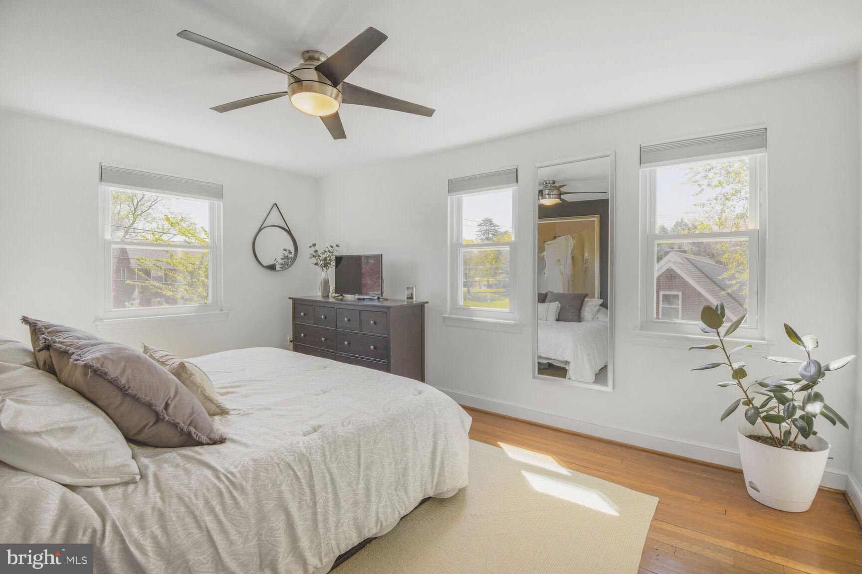 10002 Reddick Drive Silver Spring, MD 20901 - Photo 19 of 33 a bedroom with a large bed and a chandelier
