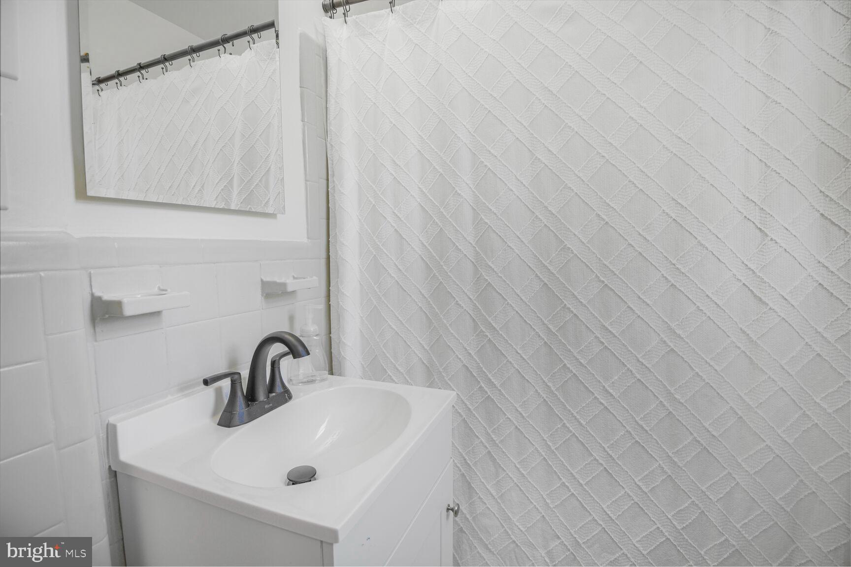 10002 Reddick Drive Silver Spring, MD 20901 - Photo 21 of 33 a bathroom with a sink and mirror