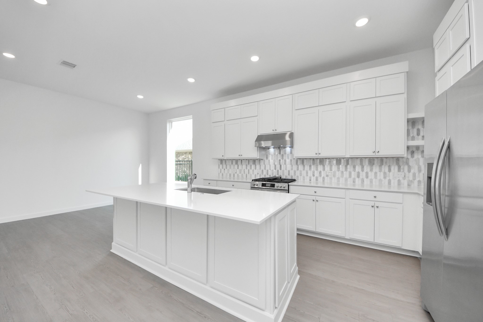 27111 Blue Pool Drive Katy, TX 77493 - Photo 13 of 38 a kitchen with white cabinets appliances and sink