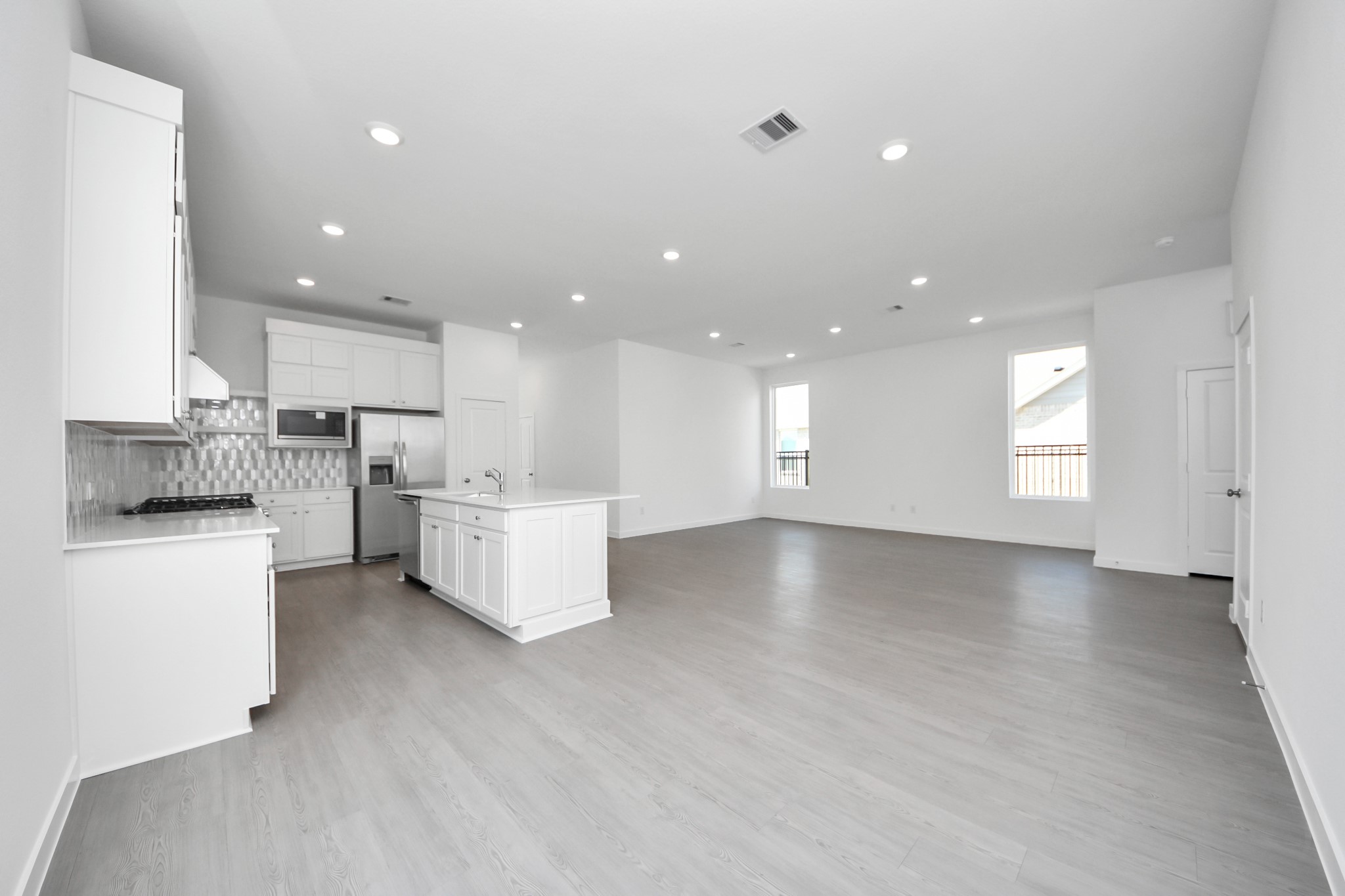 27111 Blue Pool Drive Katy, TX 77493 - Photo 9 of 38 a view of kitchen with kitchen island white cabinets and stainless steel appliances