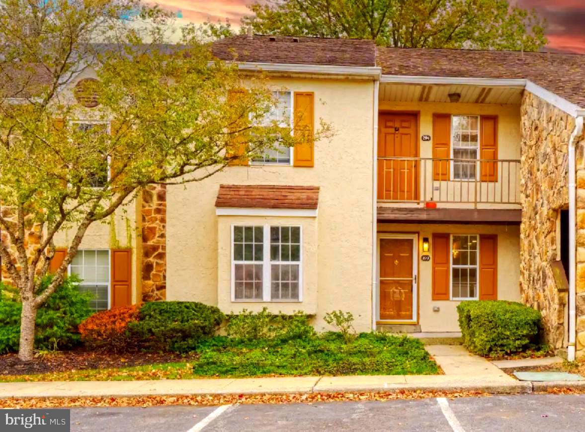 front view of a brick house with a yard
