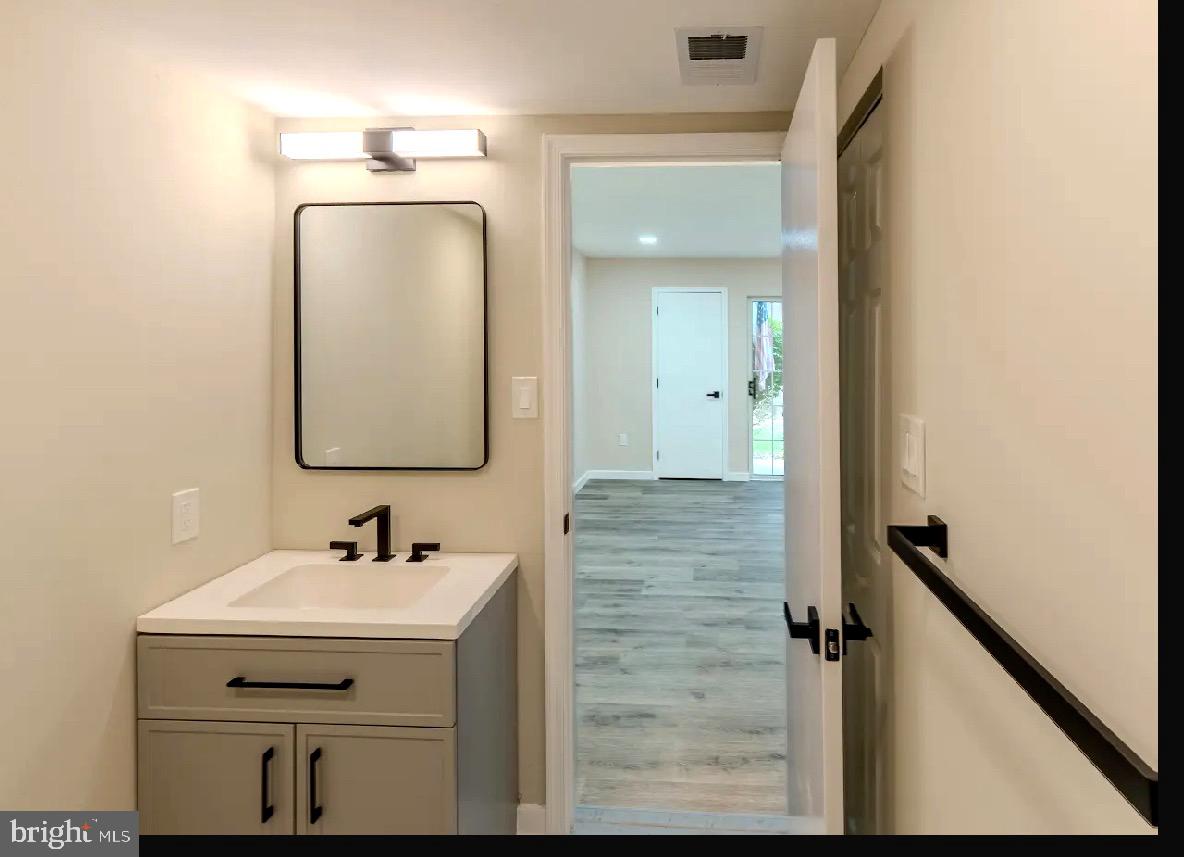 293 Valley Stream Lane, Unit 293 Chesterbrook, PA 19087 - Photo 12 of 18 a bathroom with a sink and a mirror