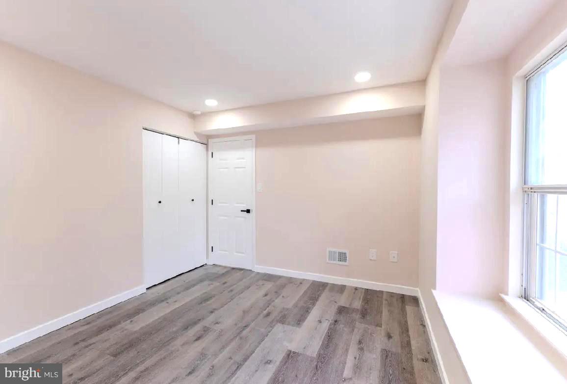 293 Valley Stream Lane, Unit 293 Chesterbrook, PA 19087 - Photo 14 of 18 wooden floor in an empty room with a window