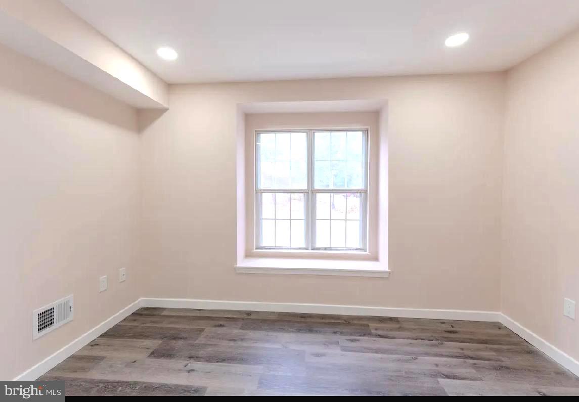 293 Valley Stream Lane, Unit 293 Chesterbrook, PA 19087 - Photo 15 of 18 an empty room with wooden floor and windows