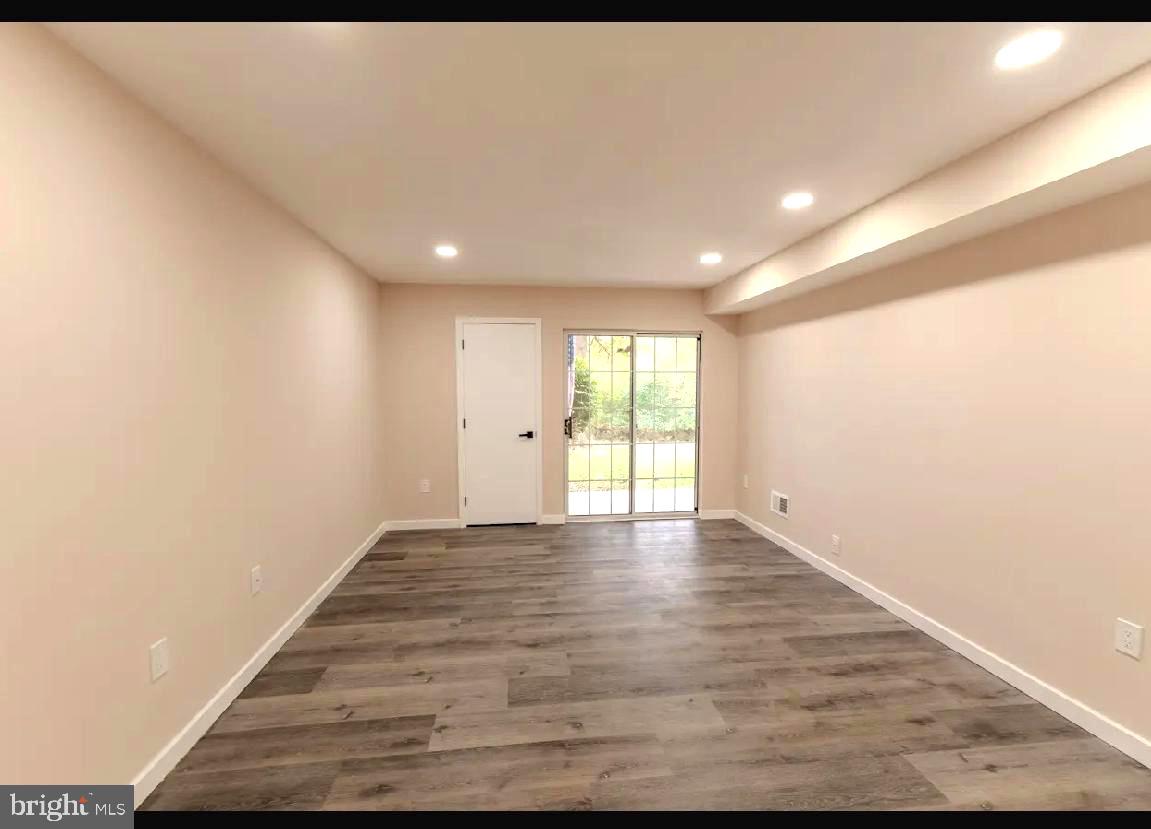 293 Valley Stream Lane, Unit 293 Chesterbrook, PA 19087 - Photo 7 of 18 a view of an empty room with wooden floor and a window
