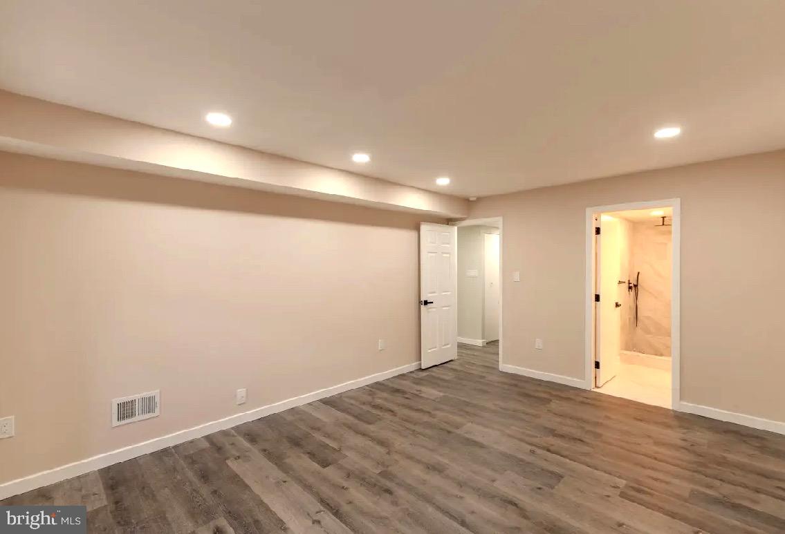 293 Valley Stream Lane, Unit 293 Chesterbrook, PA 19087 - Photo 10 of 18 an empty room with wooden floor and windows