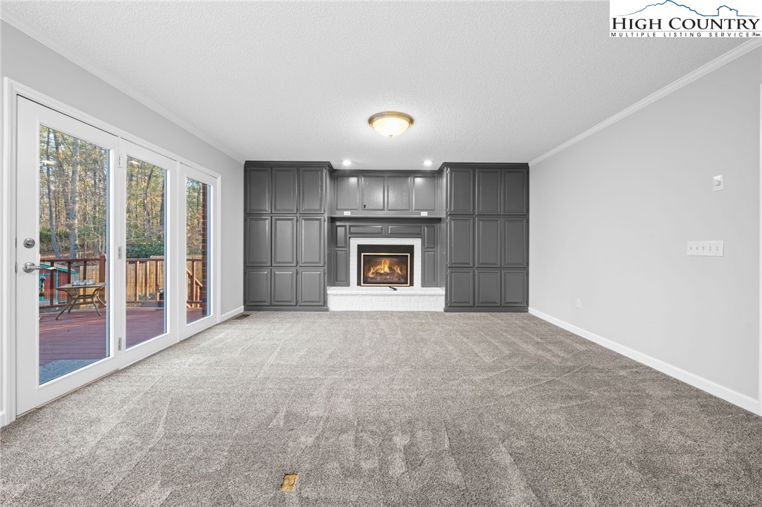 458 Jim Caudill Road Wilkesboro, NC 28697 - Photo 7 of 50 a view of an empty room with a fireplace and a window