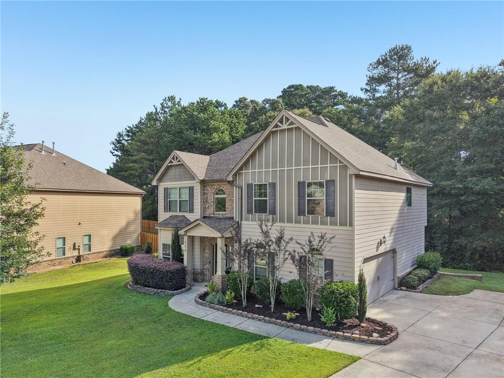 115 Tanners Court Covington, GA 30016 - Photo 21 of 60 a aerial view of a house with table and chairs under an umbrella