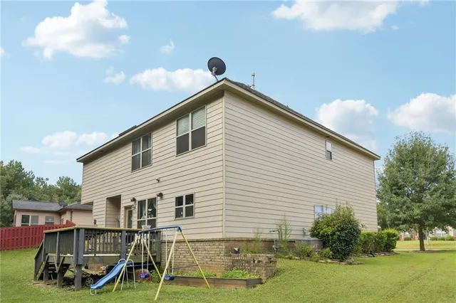 a living room with furniture a flat screen tv and a floor to ceiling window