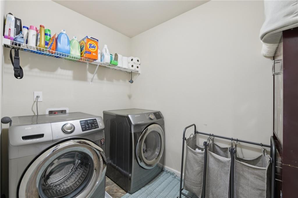 115 Tanners Court Covington, GA 30016 - Photo 35 of 60 a view of storage and utility room with washer and dryer