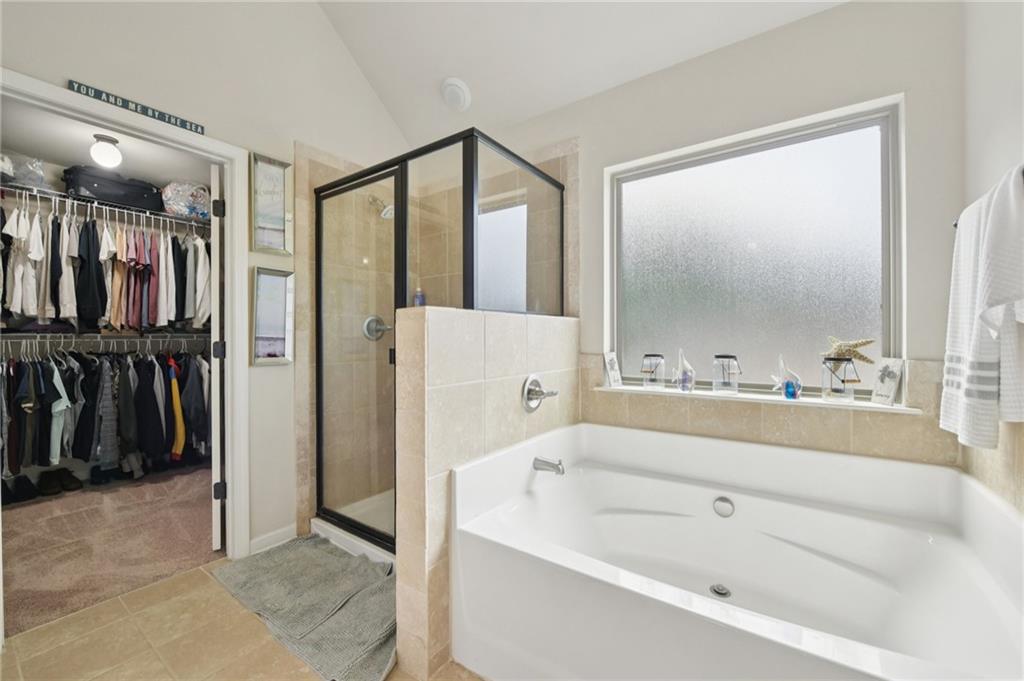 115 Tanners Court Covington, GA 30016 - Photo 38 of 60 a bathroom with a bathtub and a shower