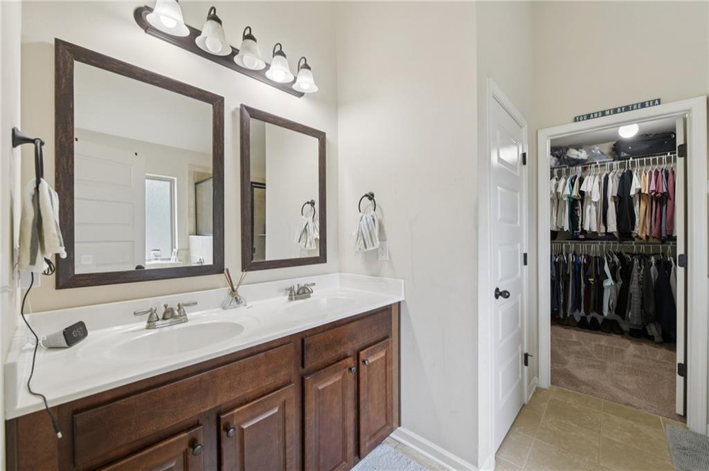 115 Tanners Court Covington, GA 30016 - Photo 39 of 60 a bathroom with a double vanity sink and a mirror