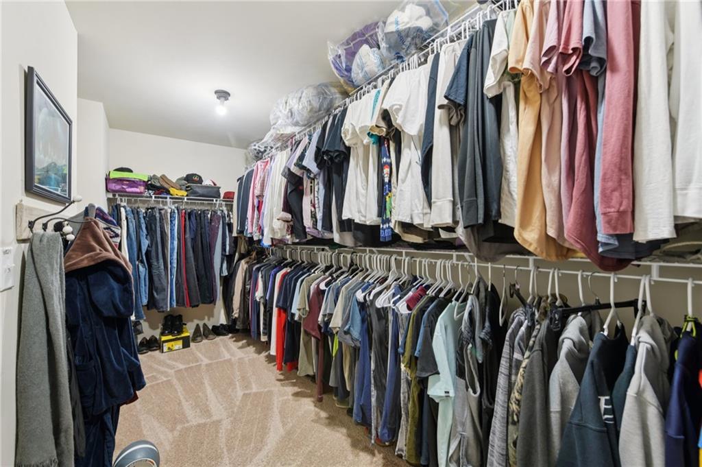 115 Tanners Court Covington, GA 30016 - Photo 40 of 60 a view of walk in closet with clothes