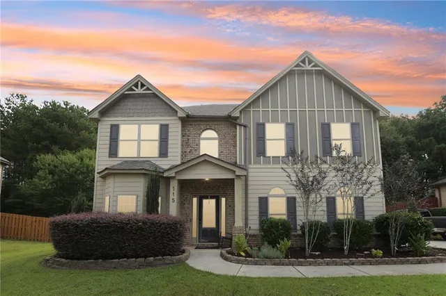 a front view of a house with garden