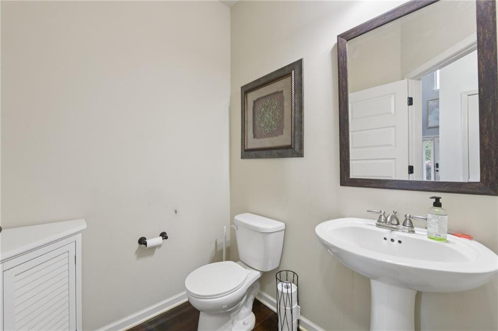 115 Tanners Court Covington, GA 30016 - Photo 43 of 60 a bathroom with a toilet sink and mirror