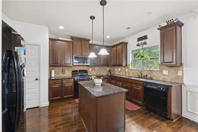 a living room with furniture and kitchen view