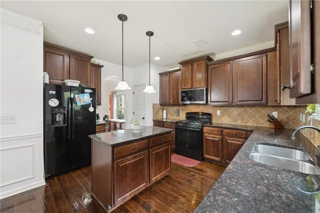 a living room with furniture a fireplace and a potted plant