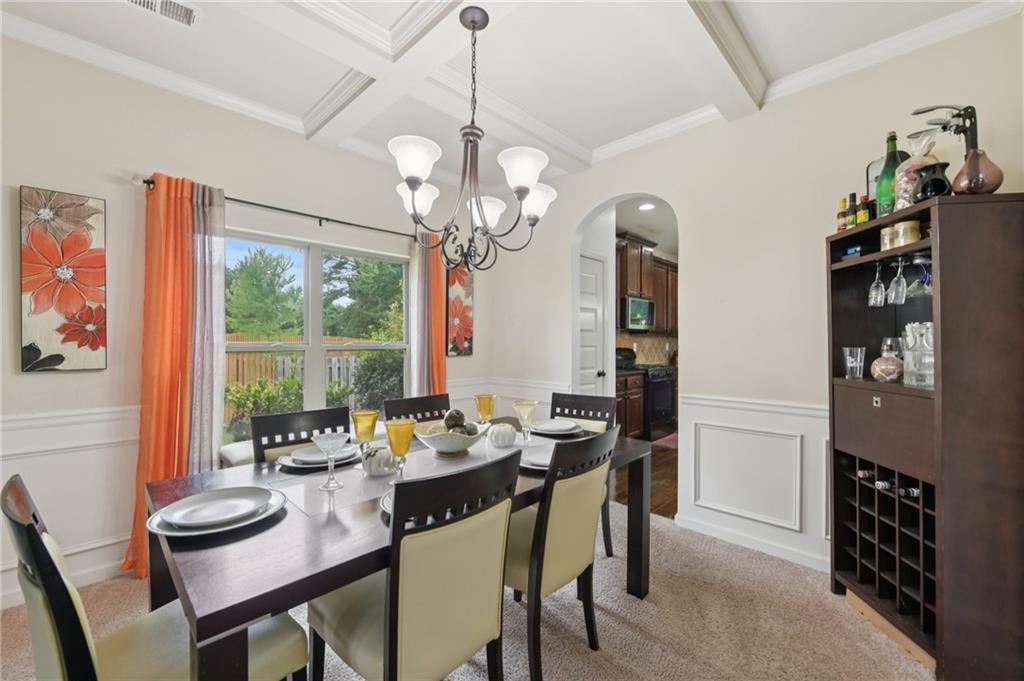 115 Tanners Court Covington, GA 30016 - Photo 48 of 60 a view of a dining room with furniture wooden floor and chandelier