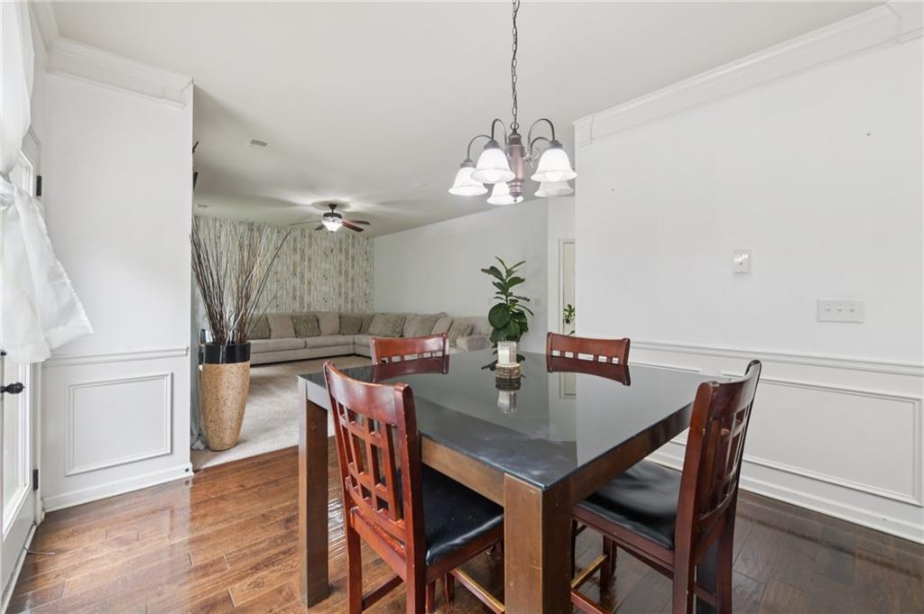 115 Tanners Court Covington, GA 30016 - Photo 50 of 60 a view of a dining room with furniture wooden floor and chandelier