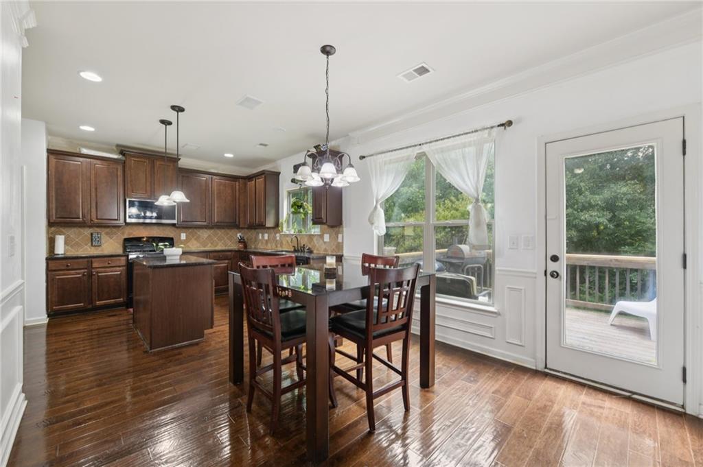 115 Tanners Court Covington, GA 30016 - Photo 51 of 60 a view of a dining room and livingroom with furniture wooden floor a chandelier