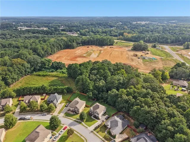 an aerial view of a house with yard swimming pool and mountains