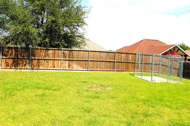 a view of a backyard with a garden and tub