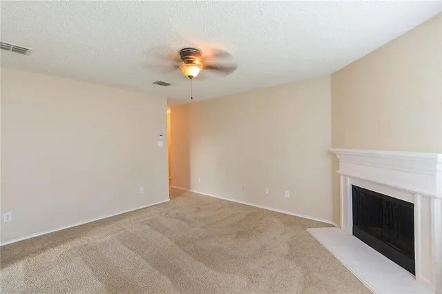 a view of an empty room with a fireplace