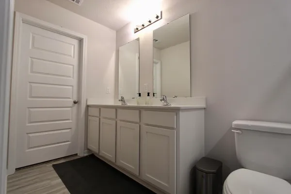 a bathroom with a sink toilet and vanity