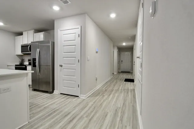 a view of hallway with wooden floor