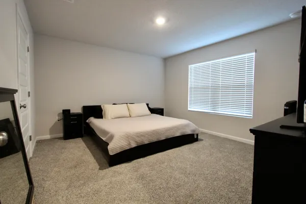 a bedroom with a bed and a window