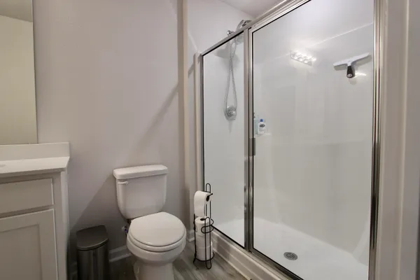 a white toilet sitting next to a bathroom sink