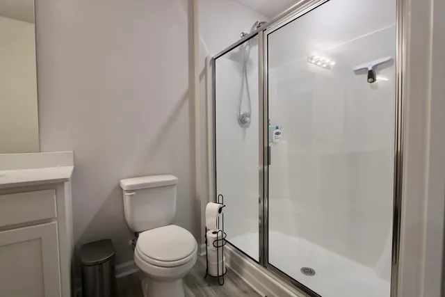 a white toilet sitting next to a bathroom sink