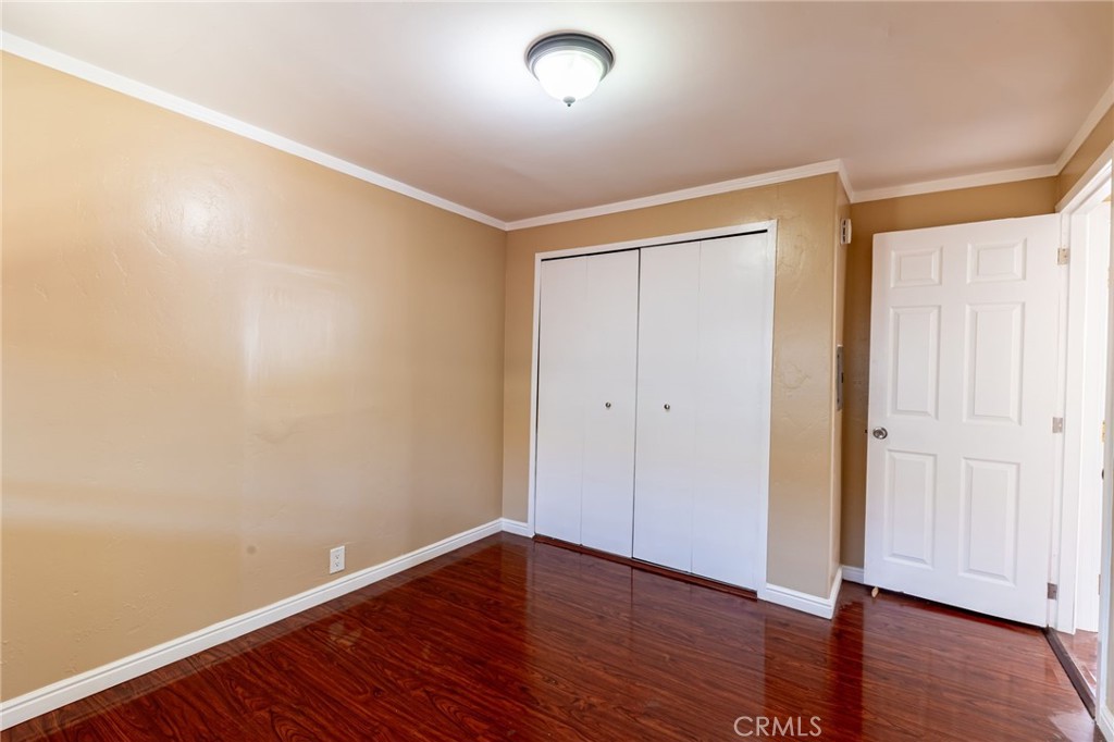 2250 West Mill Street, Unit 19 Colton, CA 92324 - Photo 13 of 27 a view of an empty room with wooden floor