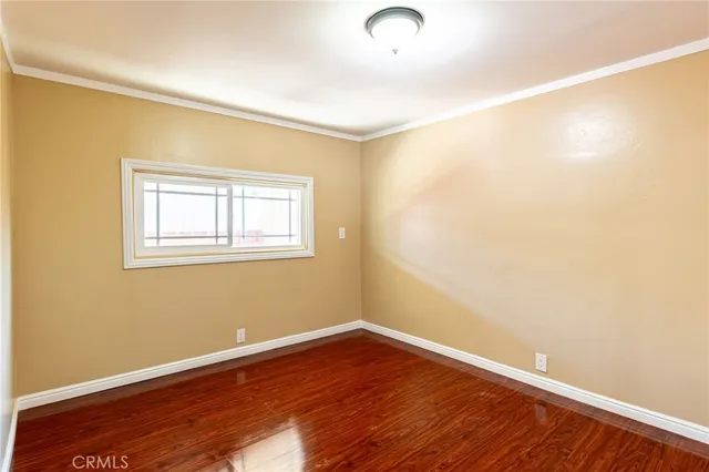 a view of a room with wooden floor and windows