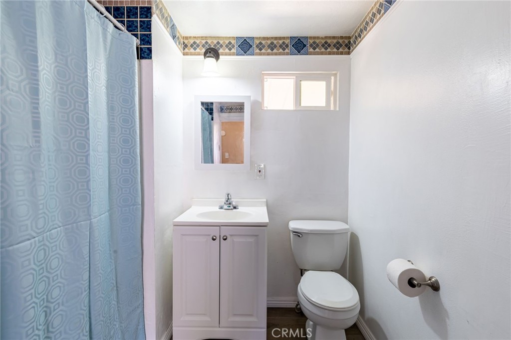 2250 West Mill Street, Unit 19 Colton, CA 92324 - Photo 15 of 27 a white toilet sitting next to a bathroom sink