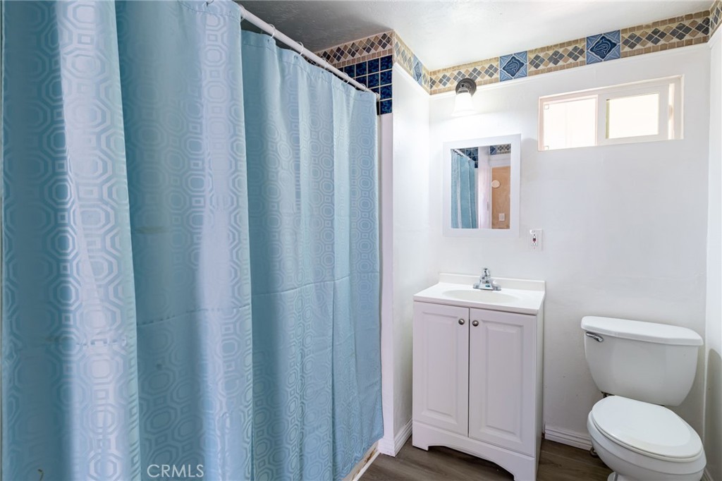 2250 West Mill Street, Unit 19 Colton, CA 92324 - Photo 16 of 27 a bathroom with a toilet a sink and a window
