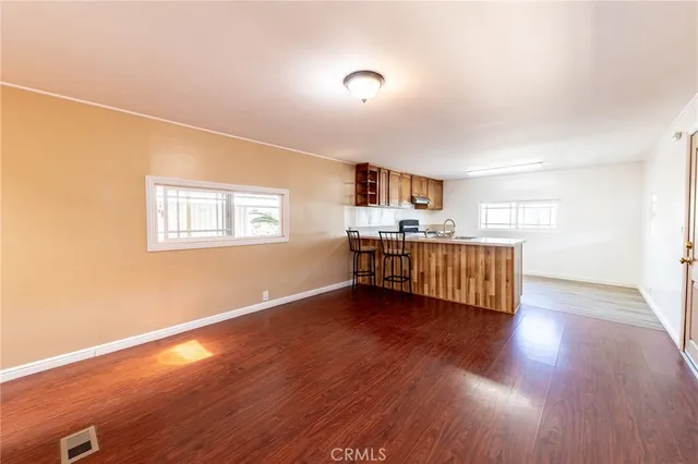 a view of a livingroom with wooden floor and a window