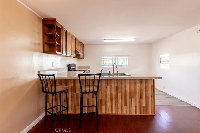 a dining room with furniture a window and wooden floor