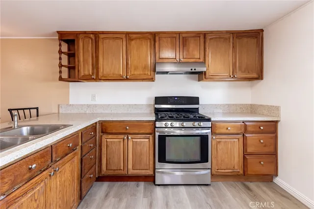 a kitchen with stainless steel appliances granite countertop a stove and a sink
