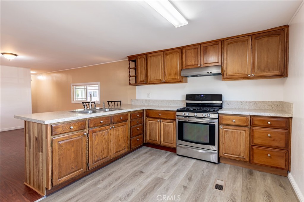 2250 West Mill Street, Unit 19 Colton, CA 92324 - Photo 9 of 27 a kitchen with stainless steel appliances granite countertop a stove cabinets and wooden floor