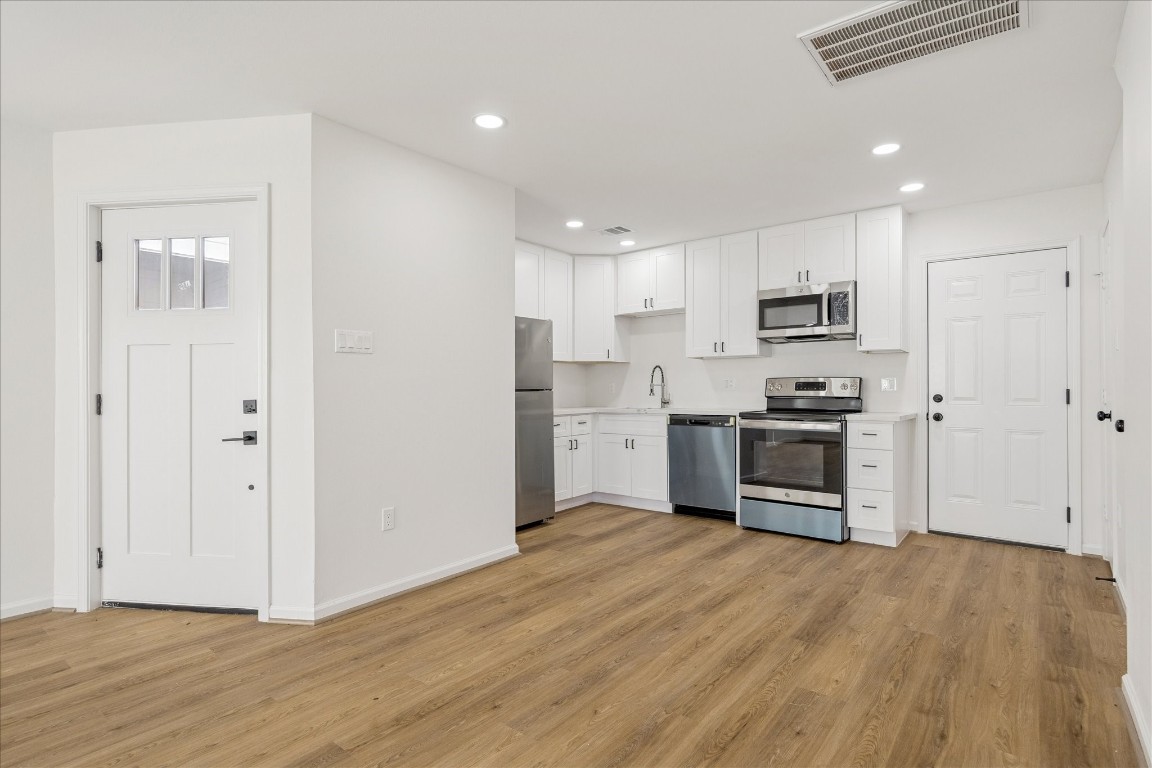9913 Porto Rico Road Houston, TX 77041 - Photo 14 of 34 a kitchen with stainless steel appliances a refrigerator sink and cabinets