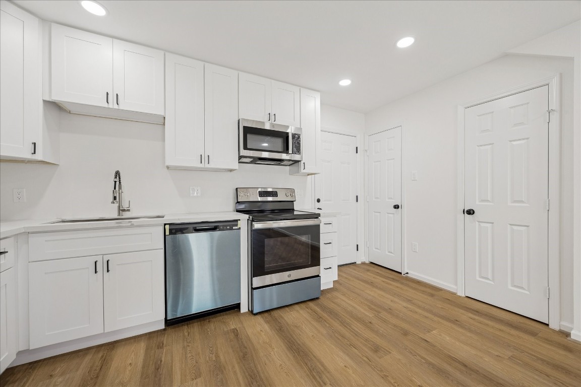 9913 Porto Rico Road Houston, TX 77041 - Photo 15 of 34 a kitchen with stainless steel appliances white cabinets and a sink