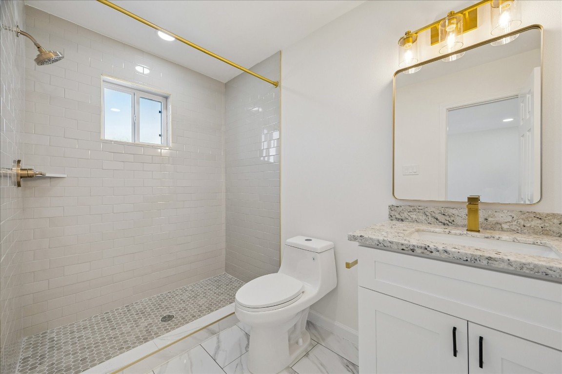 9913 Porto Rico Road Houston, TX 77041 - Photo 22 of 34 a bathroom with a granite countertop sink toilet and shower