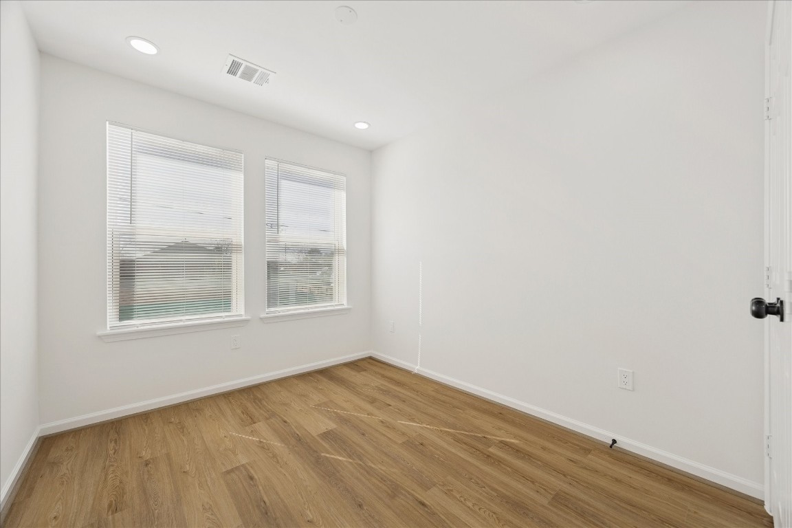 9913 Porto Rico Road Houston, TX 77041 - Photo 25 of 34 an empty room with wooden floor and windows