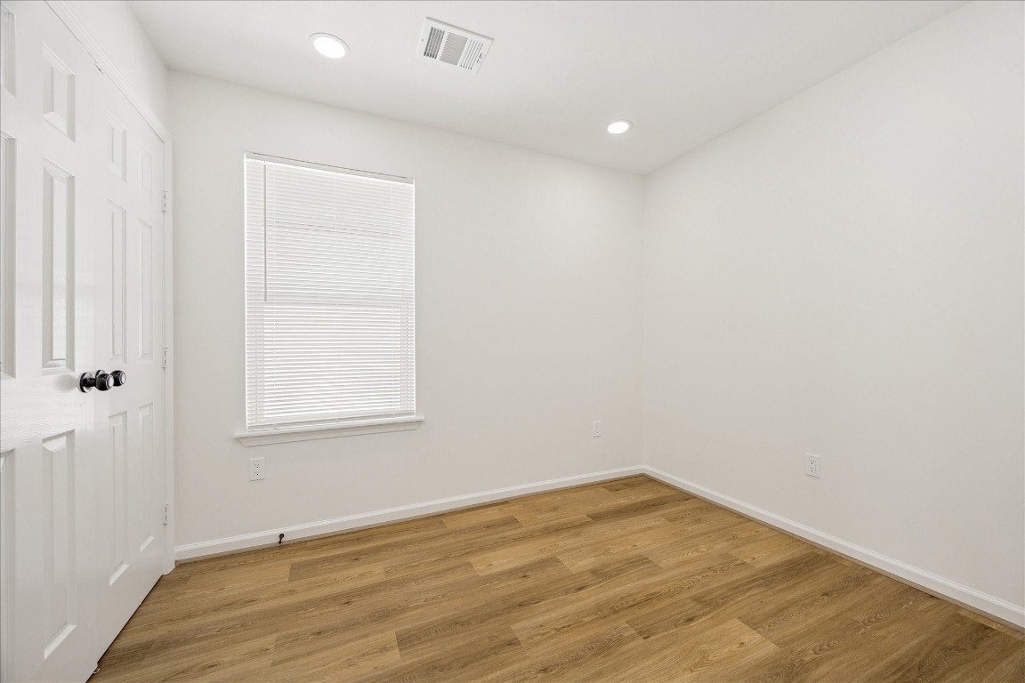9913 Porto Rico Road Houston, TX 77041 - Photo 27 of 34 an empty room with wooden floor and windows