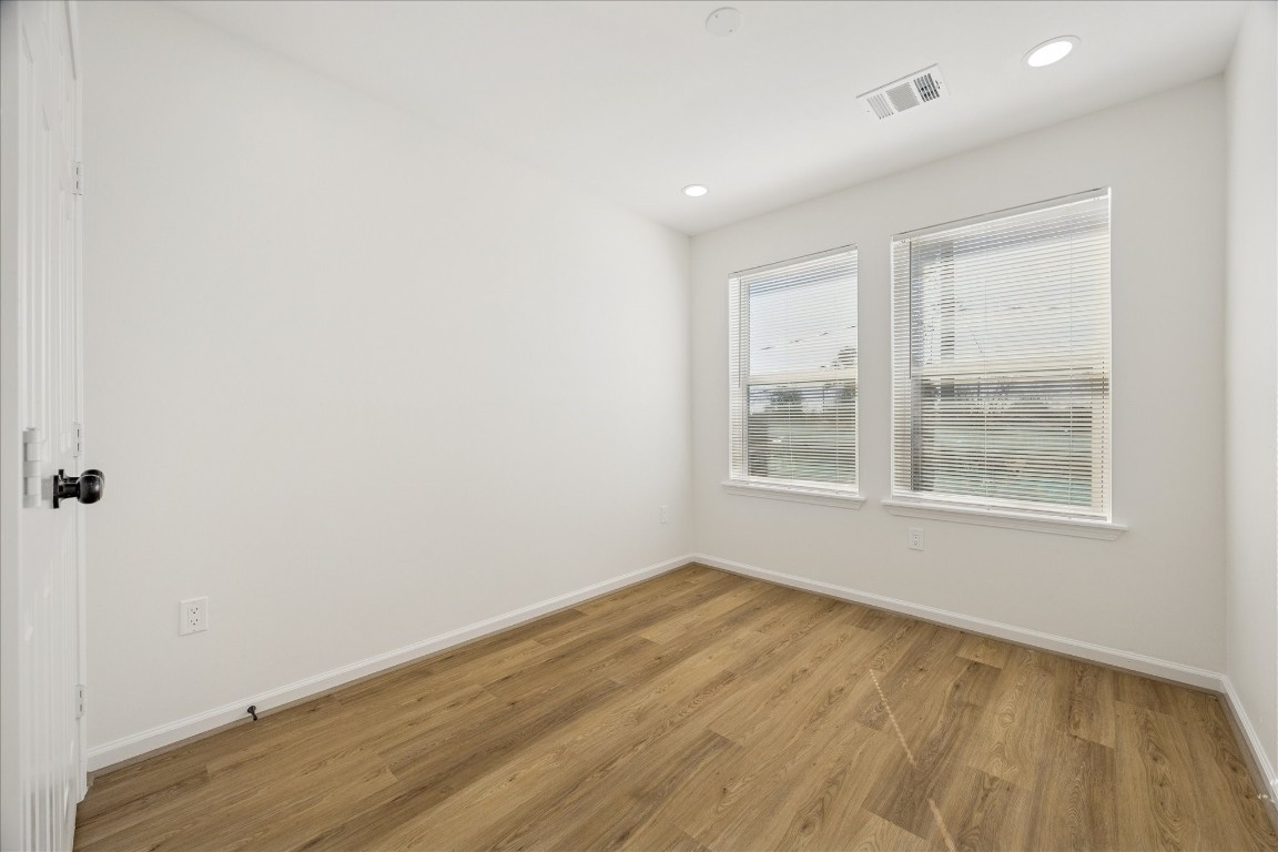 9913 Porto Rico Road Houston, TX 77041 - Photo 10 of 34 an empty room with wooden floor and windows