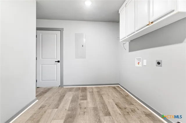 a view of a room with wooden floor and white walls