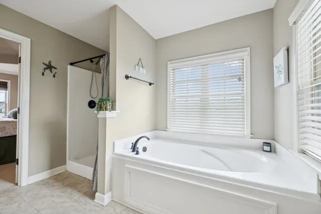 a white bath tub sitting next to a window