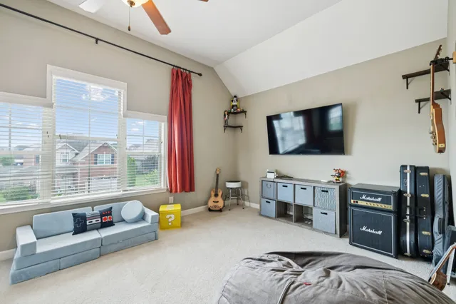 a bedroom with furniture and a flat screen tv